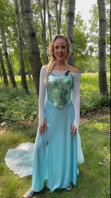 Transform into the Snow Queen with this exclusive Women's Premium Disney Frozen Elsa Costume. Featuring a stunning ice-blue dress with intricate details and a flowing cape, this high-quality costume is perfect for Halloween, or cosplay.