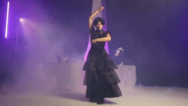 Step into the spotlight with this exclusive Wednesday Addams Rave’N Dance Women’s Costume Dress, inspired by the iconic scene that had everyone talking. This flowing black gown captures Wednesday’s eerie elegance with its dramatic sheer sleeves, layered skirt, and gothic charm that moves beautifully as you dance.